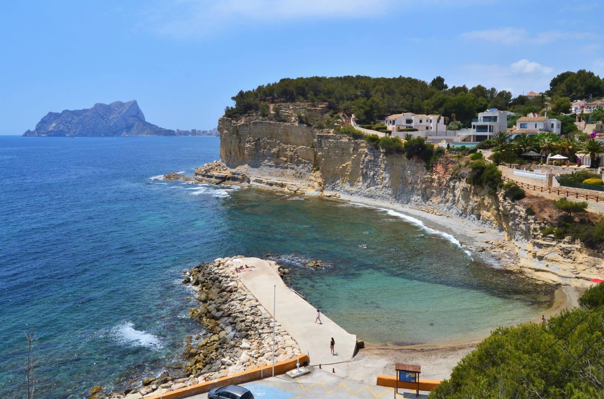 Cala de l'Advocat and the cliff-top villas of Benissa Costa, with the Peñón de Ifach in the background, Costa Blanca